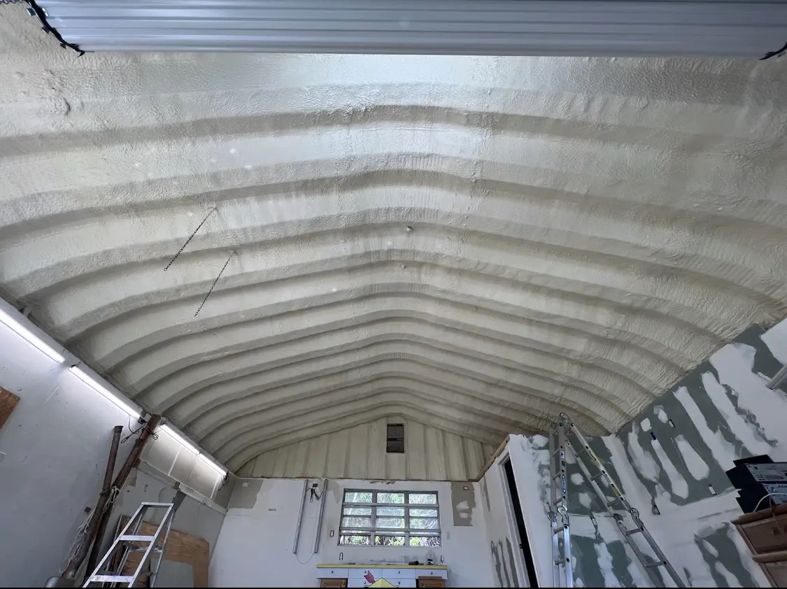 Spray polyurethane foam applied to the underside of a metal roof deck in Costa Mesa